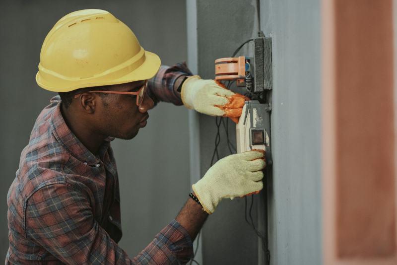 An electrician wiring a NEMA 14-50 receptacle, the finished work to install a 240V outlet for a range or EV charger